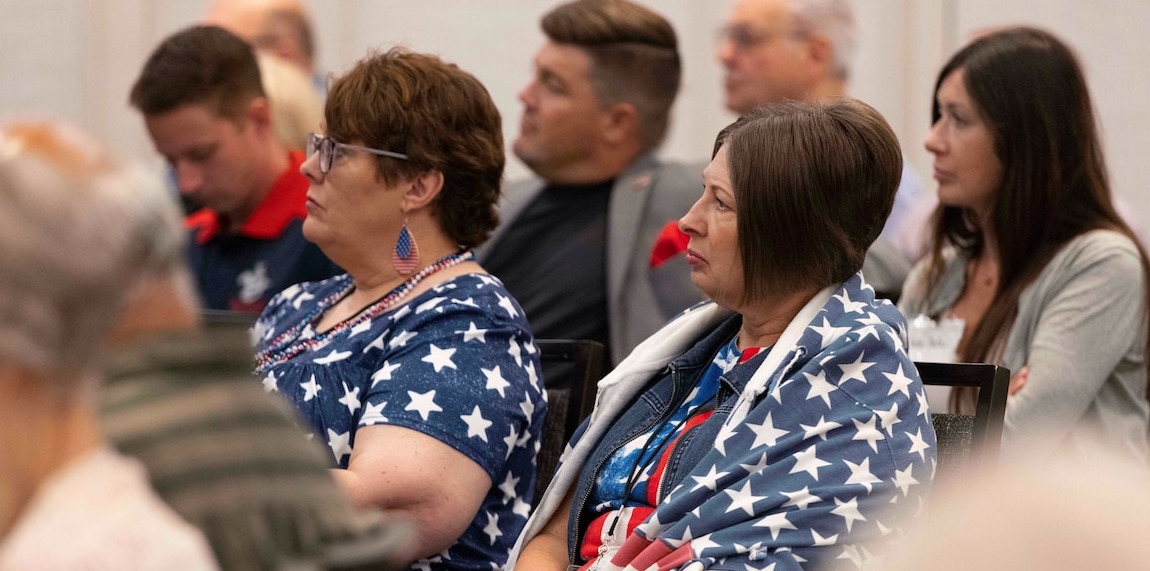 Woman sits with American flag jacket
